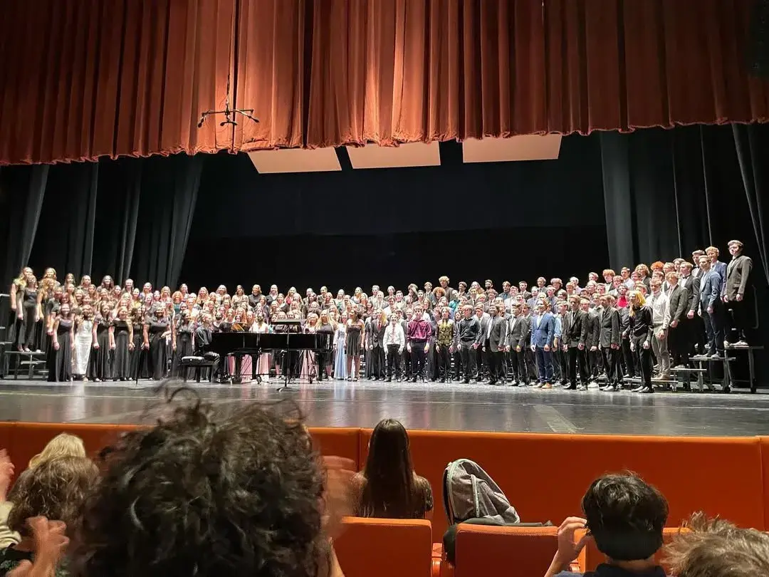 Hundreds of honor choir singers standing on a stage