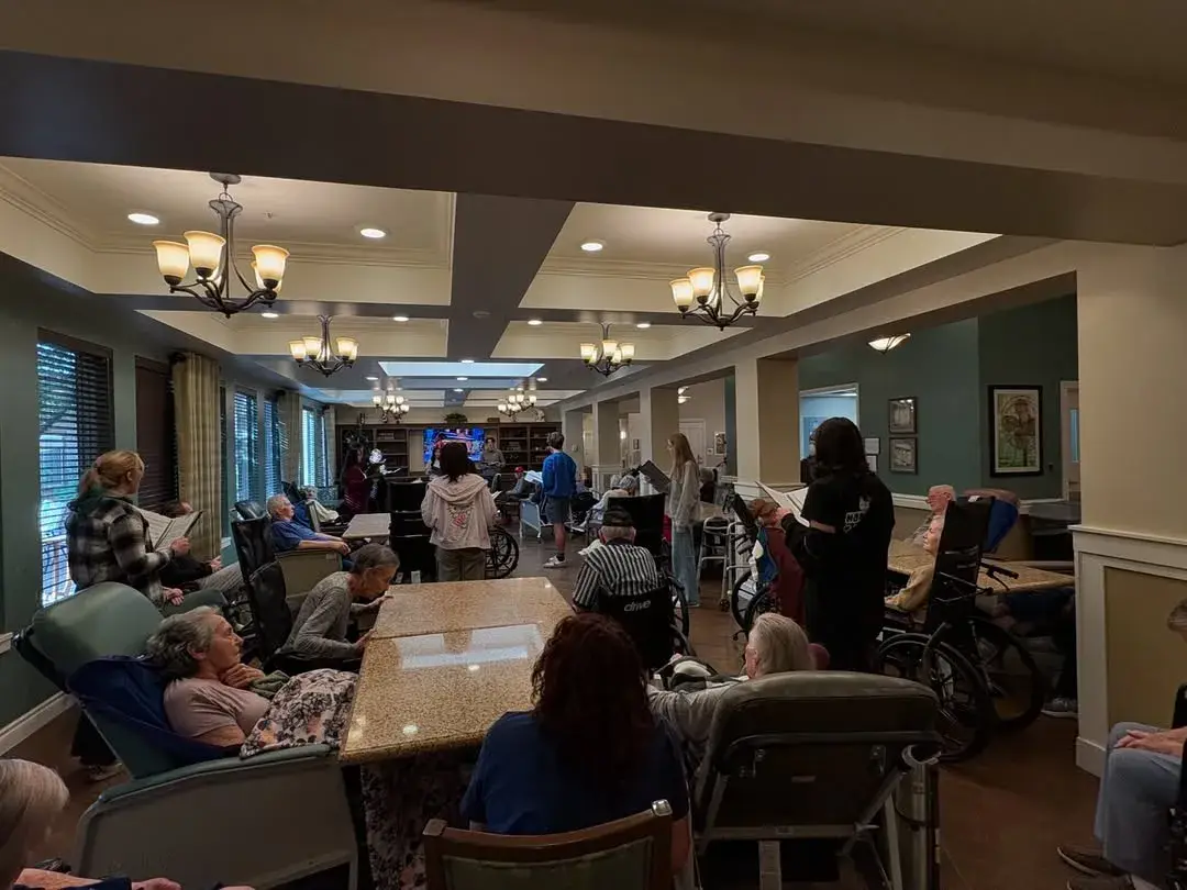 Hamilton singers caroling for residents in a memory care dining room