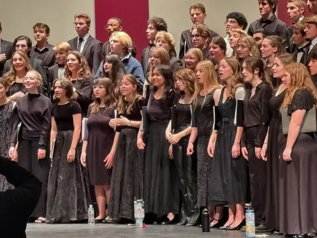 Rows of singers in black on stage at the Southwest Regional Choir