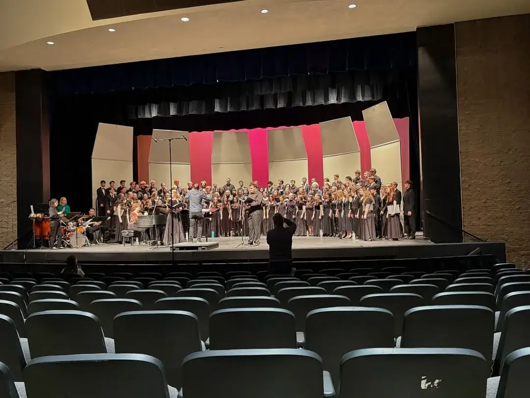 A massed honor choir on stage with Hamilton singers among them