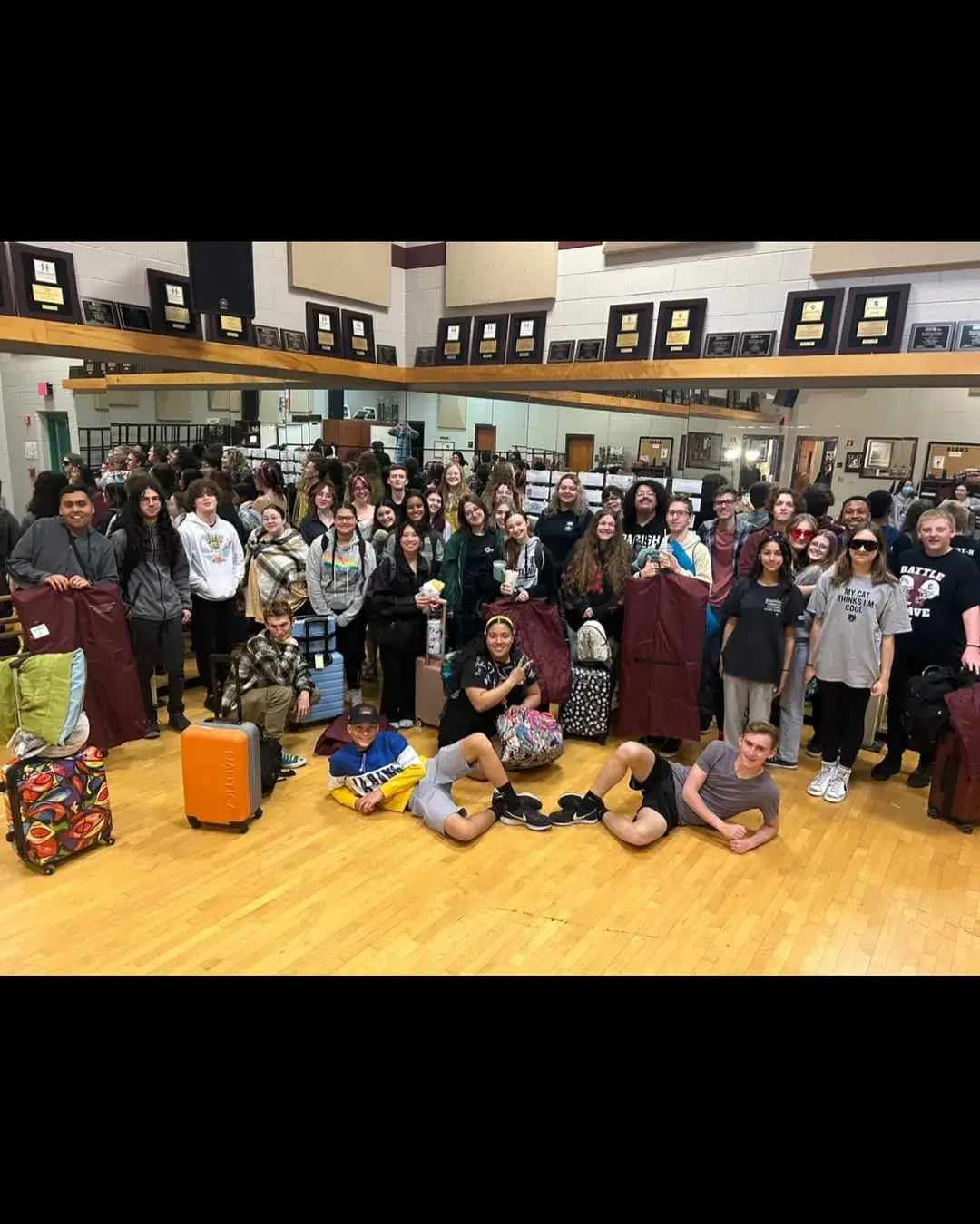 A large group of Hamilton choir and orchestra students posing together on tour